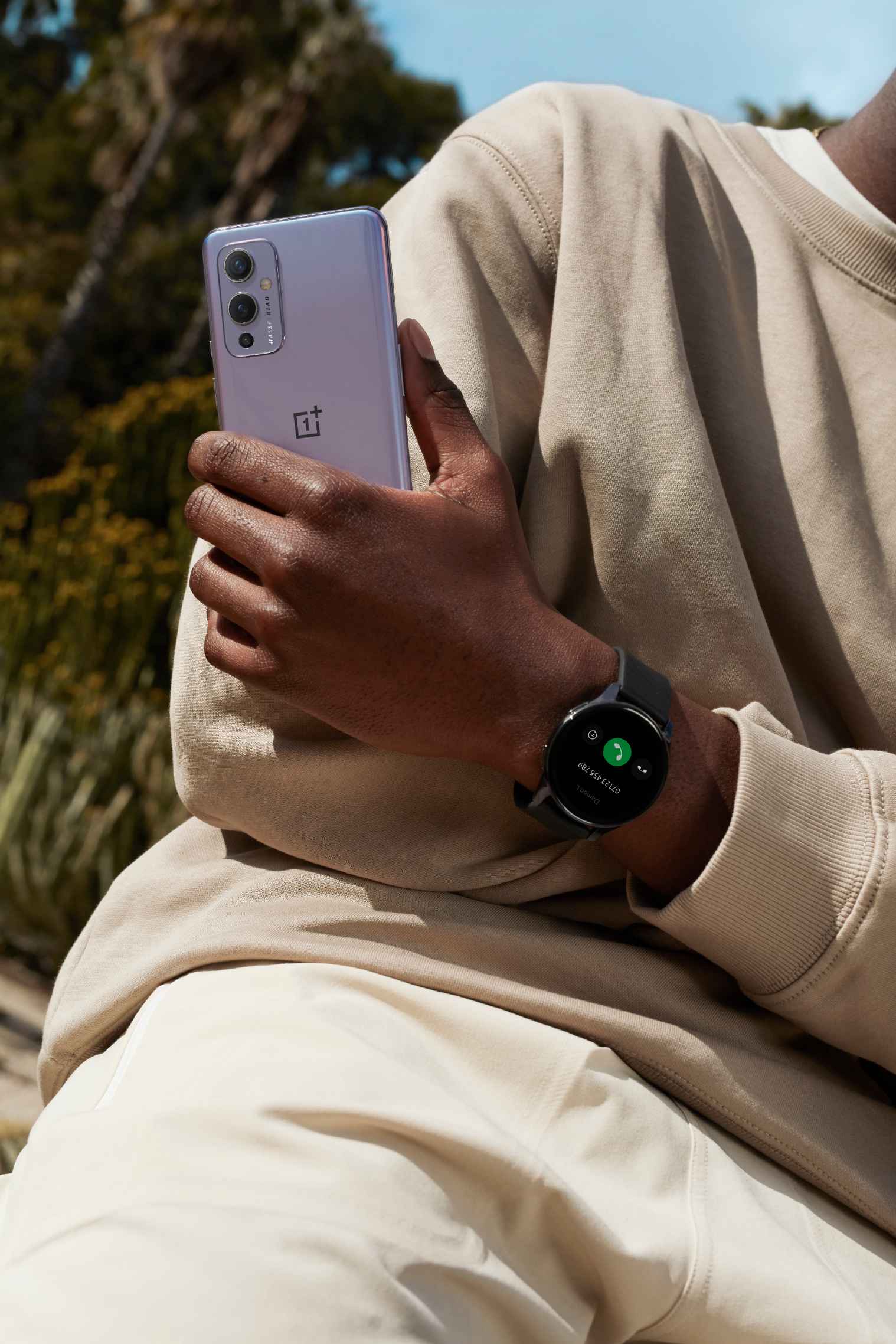 A Male Model Holding a OnePlus 9 5G Phone